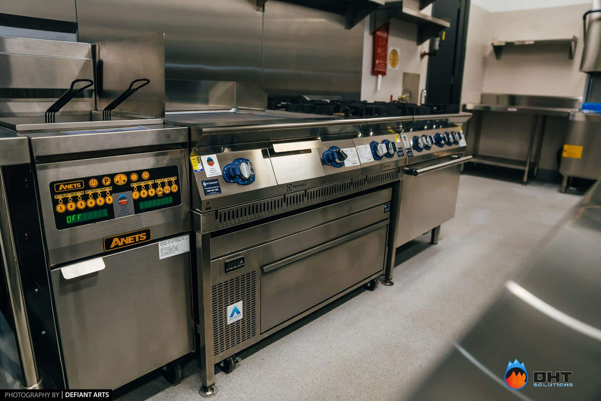 Anets gas fryer beside the Electrolux cooking suite, with an Adande refrigerated drawer built in underneath