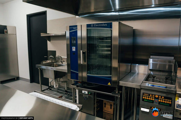 Electrolux air-o-convect combi oven on its stand between the hand sink and the fryer