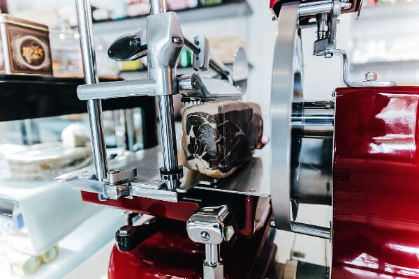 Vintage style slicer slicing thin meat