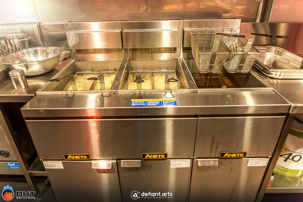 The three-bay Anets fryer bank with baskets in the oil