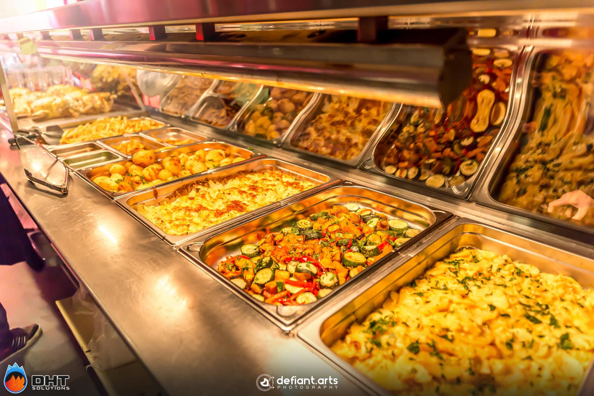 Hot food display holding roast vegetables and sides under the heat lamps