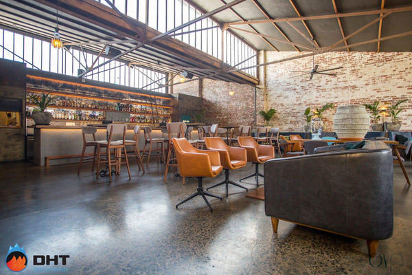 The upstairs bar at Galah, with the long back bar and lounge seating under the sawtooth roof