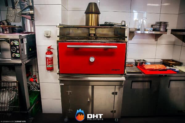 Red Josper charcoal oven with stainless steel base standing in the History Cafe kitchen
