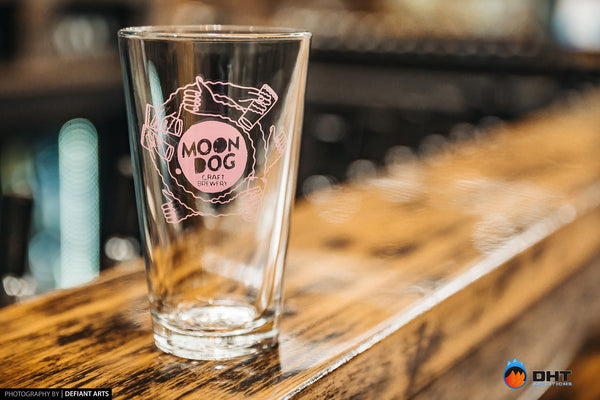 A Moon Dog Craft Brewery glass on the timber bar top