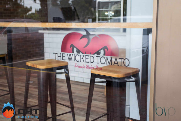 The Wicked Tomato shopfront window, with bar stools at the window bench